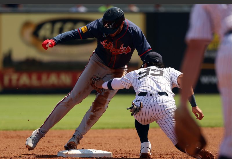 Mar 10, 2024; Tampa, Florida, USA; New York Yankees infielder Oswaldo Cabrera (95) tags out Atlanta Braves infielder Forrest Wall (73) during the first inning at George M. Steinbrenner Field. Mandatory Credit: Kim Klement Neitzel-USA TODAY Sports