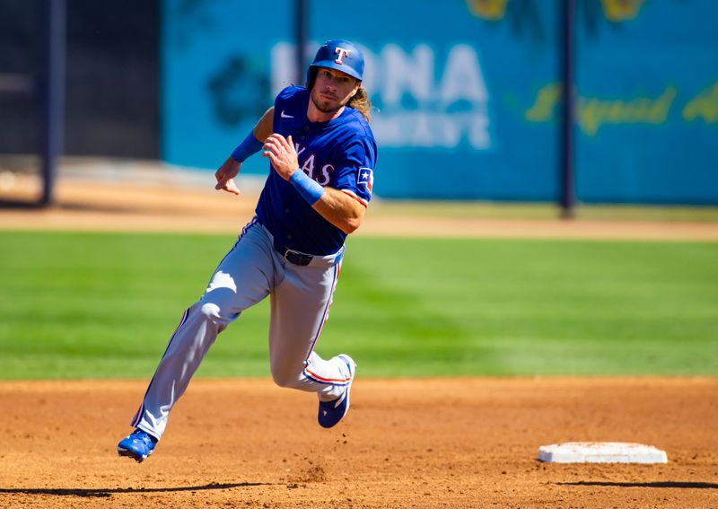 Mar 5, 2024; Peoria, Arizona, USA; Texas Rangers outfielder Travis Jankowski runs the bases against the Seattle Mariners during a spring training baseball game at Peoria Sports Complex. Mandatory Credit: Mark J. Rebilas-USA TODAY Sports