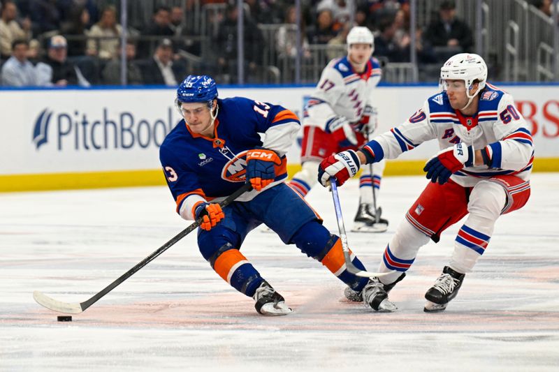 Jan 28, 2026; Elmont, New York, USA;  New York Islanders center Mathew Barzal (13) makes a move defended by New York Rangers left wing Will Cuylle (50) during the first period at UBS Arena. Mandatory Credit: Dennis Schneidler-Imagn Images