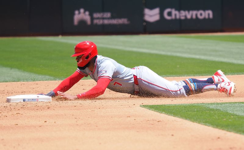 Jul 4, 2024; Oakland, California, USA; Los Angeles Angels right fielder Jo Adell (7) steals second base against the Oakland Athletics during the third inning at Oakland-Alameda County Coliseum. Mandatory Credit: Kelley L Cox-USA TODAY Sports