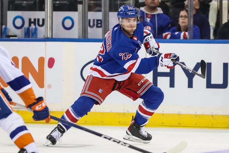 Sep 26, 2023; New York, New York, USA;  New York Rangers center Jonny Brodzinski (22) passes the puck in the first period against the New York Islanders at Madison Square Garden. Mandatory Credit: Wendell Cruz-USA TODAY Sports