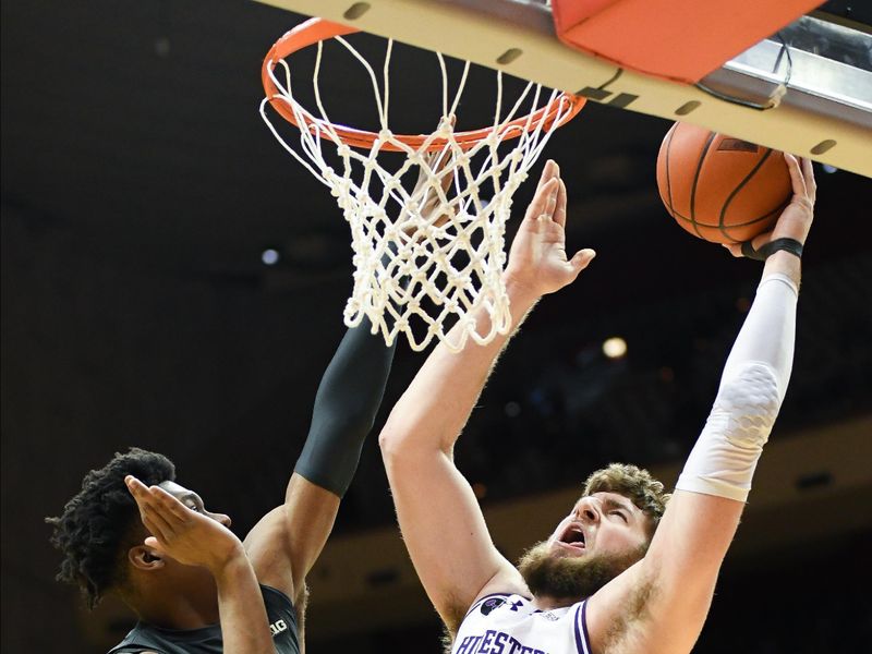 Feb 18, 2024; Bloomington, Indiana, USA;  Northwestern Wildcats center Matthew Nicholson (34) goes up for a dunk against Indiana Hoosiers forward Anthony Walker (4) during the second half at Simon Skjodt Assembly Hall. Mandatory Credit: Robert Goddin-USA TODAY Sports