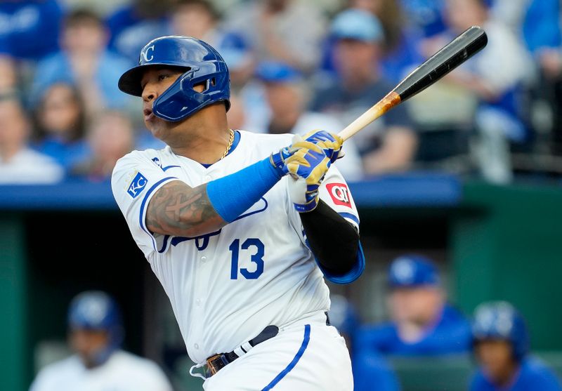 Apr 24, 2024; Kansas City, Missouri, USA; Kansas City Royals catcher Salvador Perez (13) hits an RBI single during the first inning against the Toronto Blue Jays at Kauffman Stadium. Mandatory Credit: Jay Biggerstaff-USA TODAY Sports