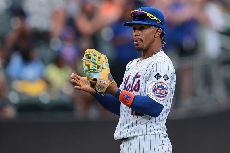 Aug 18, 2024; New York City, New York, USA; New York Mets shortstop Francisco Lindor (12) wears a special players weekend glove during the third inning against the Miami Marlins at Citi Field. Mandatory Credit: Vincent Carchietta-USA TODAY Sports