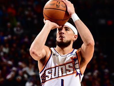 PHOENIX, AZ - DECEMBER 25: Devin Booker #1 of the Phoenix Suns shoots a free throw during the game against the Dallas Mavericks on December 25, 2023 at Footprint Center in Phoenix, Arizona. NOTE TO USER: User expressly acknowledges and agrees that, by downloading and or using this photograph, user is consenting to the terms and conditions of the Getty Images License Agreement. Mandatory Copyright Notice: Copyright 2023 NBAE (Photo by Barry Gossage/NBAE via Getty Images)