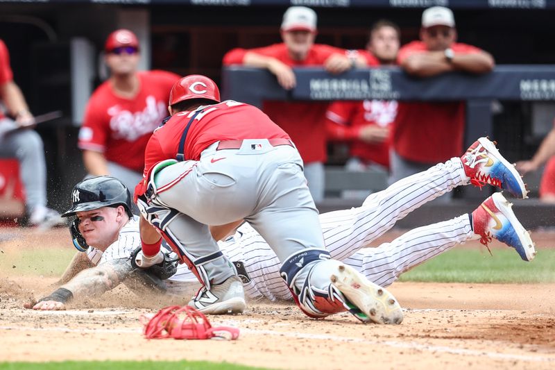 Jul 4, 2024; Bronx, New York, USA; New York Yankees left fielder Alex Verdugo (24) is tagged out at home plate by Cincinnati Reds catcher Luke Maile (22) in the sixth inning at Yankee Stadium. Mandatory Credit: Wendell Cruz-USA TODAY Sports