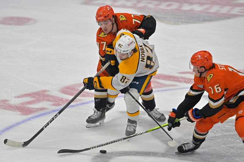 Jan 25, 2025; Anaheim, California, USA; Anaheim Ducks right wing Frank Vatrano (77), Nashville Predators center Tommy Novak (82) and Anaheim Ducks center Ryan Strome (16) battle for the puck in the first period at Honda Center. Mandatory Credit: Jayne Kamin-Oncea-Imagn Images