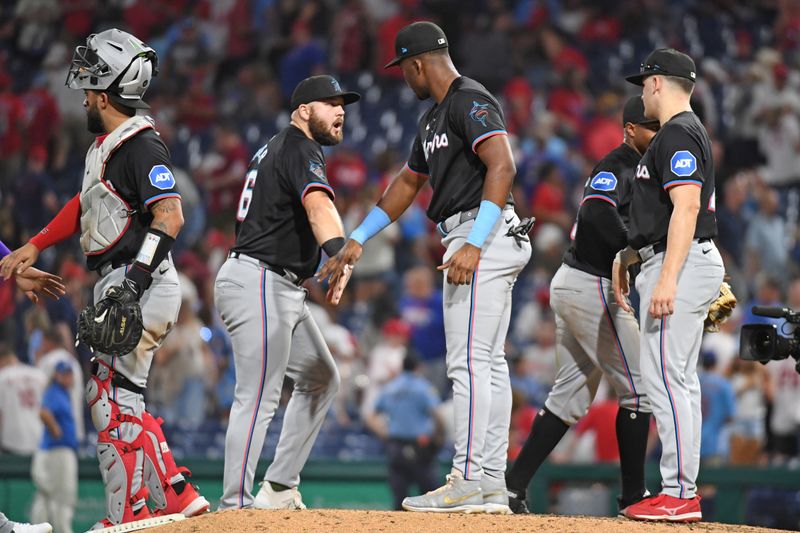 Aug 13, 2024; Philadelphia, Pennsylvania, USA; Miami Marlins third base Jake Burger (36) and outfielder Jesús Sánchez (12) celebrate win against the Philadelphia Phillies at Citizens Bank Park. Mandatory Credit: Eric Hartline-USA TODAY Sports