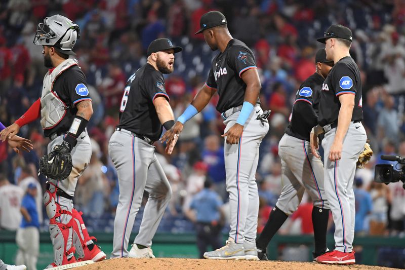 Aug 13, 2024; Philadelphia, Pennsylvania, USA; Miami Marlins third base Jake Burger (36) and outfielder Jesús Sánchez (12) celebrate win against the Philadelphia Phillies at Citizens Bank Park. Mandatory Credit: Eric Hartline-USA TODAY Sports