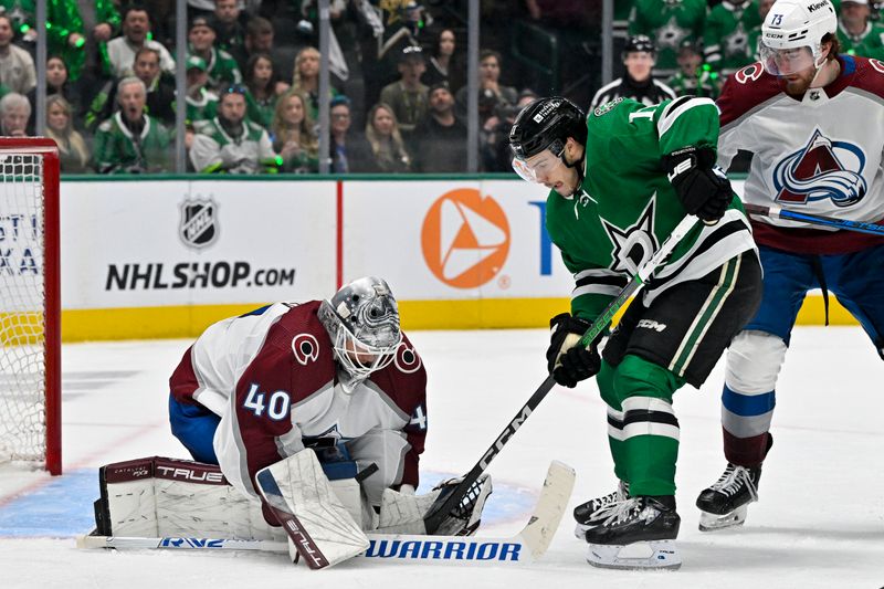 May 7, 2024; Dallas, Texas, USA; Dallas Stars center Logan Stankoven (11) attempts to redirect the puck past Colorado Avalanche goaltender Alexandar Georgiev (40) as center Yakov Trenin (73) looks on during the overtime period in game one of the second round of the 2024 Stanley Cup Playoffs at American Airlines Center. Mandatory Credit: Jerome Miron-USA TODAY Sports