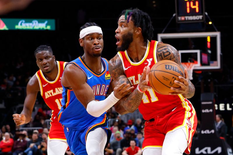 ATLANTA, GEORGIA - JANUARY 3: Saddiq Bey #41 of the Atlanta Hawks drives against Shai Gilgeous-Alexander #2 of the Oklahoma City Thunder during the second half at State Farm Arena on January 3, 2024 in Atlanta, Georgia. NOTE TO USER: User expressly acknowledges and agrees that, by downloading and or using this photograph, User is consenting to the terms and conditions of the Getty Images License Agreement. (Photo by Todd Kirkland/Getty Images)