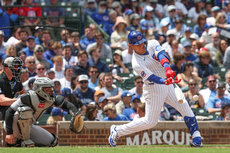May 17, 2025; Chicago, Illinois, USA; Chicago Cubs catcher Miguel Amaya (9) hits a two-run single against the Chicago White Sox during the second inning at Wrigley Field. Mandatory Credit: Kamil Krzaczynski-Imagn Images