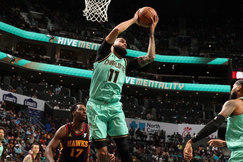 CHARLOTTE, NC - NOVEMBER 30: Cody Martin #11 of the Charlotte Hornets rebounds the ball during the game against the Atlanta Hawks on November 30, 2024 at Spectrum Center in Charlotte, North Carolina. NOTE TO USER: User expressly acknowledges and agrees that, by downloading and or using this photograph, User is consenting to the terms and conditions of the Getty Images License Agreement. Mandatory Copyright Notice: Copyright 2024 NBAE (Photo by Kent Smith/NBAE via Getty Images)
