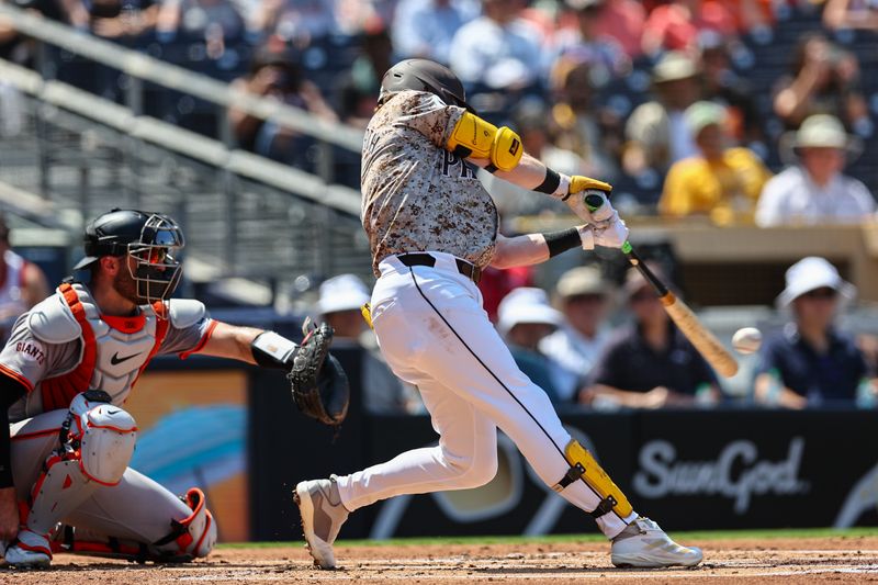 Sep 8, 2024; San Diego, California, USA; San Diego Padres first baseman Jake Cronenworth (9) hits a single during the second inning against the San Francisco Giants at Petco Park. Mandatory Credit: Chadd Cady-Imagn Images