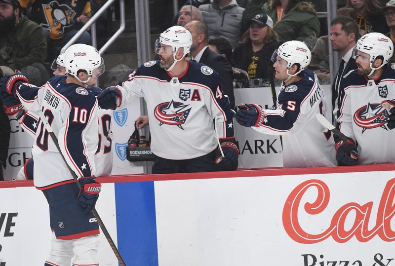 Oct 25, 2025; Pittsburgh, Pennsylvania, USA; Columbus Blue Jackets left wing Dmitri Voronkov (10) is greeted by the bench after scxoring against the Pittsburgh Penguins during the third period at PPG Paints Arena. Mandatory Credit: Philip G. Pavely-Imagn Images