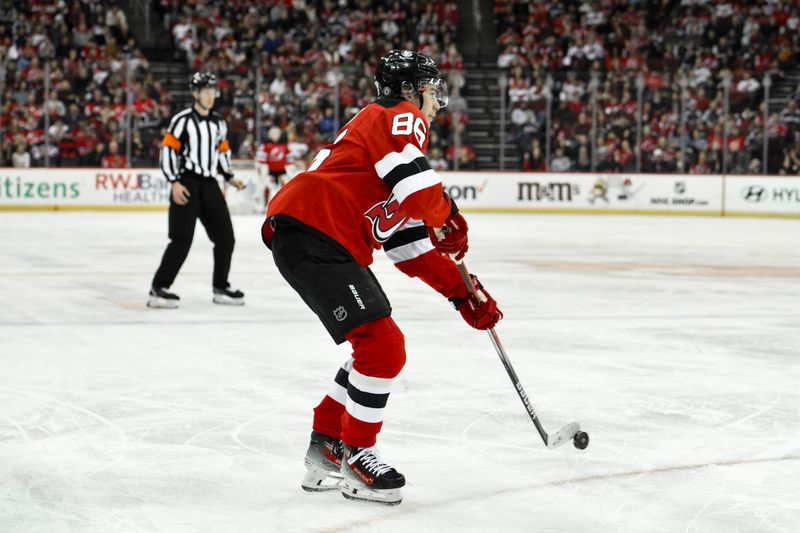 Feb 24, 2024; Newark, New Jersey, USA; New Jersey Devils center Jack Hughes (86) passes the puck during the second period against the Montreal Canadiens at Prudential Center. Mandatory Credit: John Jones-USA TODAY Sports