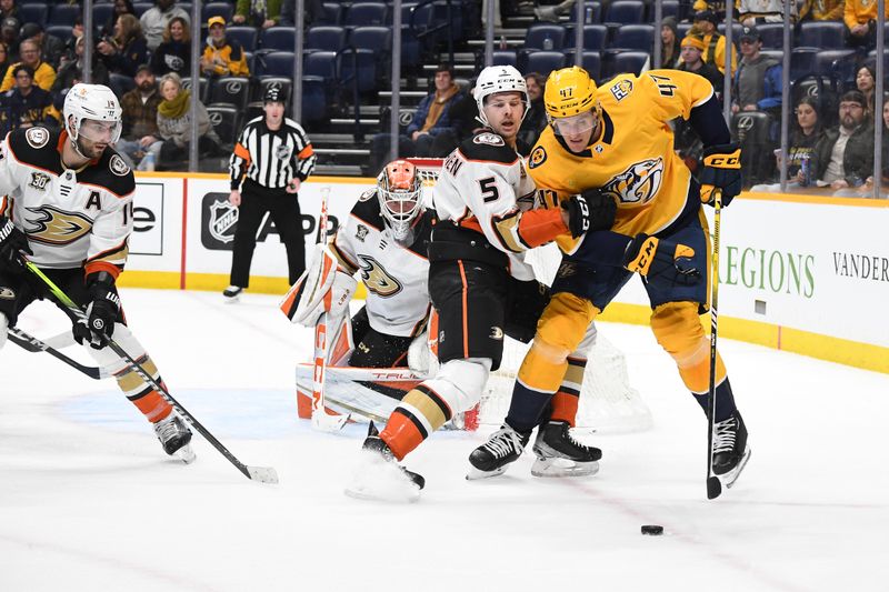 Jan 9, 2024; Nashville, Tennessee, USA; Nashville Predators right wing Michael McCarron (47) handles the puck against Anaheim Ducks defenseman Urho Vaakanainen (5) during the third period at Bridgestone Arena. Mandatory Credit: Christopher Hanewinckel-USA TODAY Sports