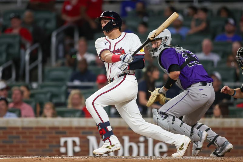 Sep 3, 2024; Atlanta, Georgia, USA; Atlanta Braves third baseman Gio Urshela (9) hits a single against the Colorado Rockies in the seventh inning at Truist Park. Mandatory Credit: Brett Davis-Imagn Images 