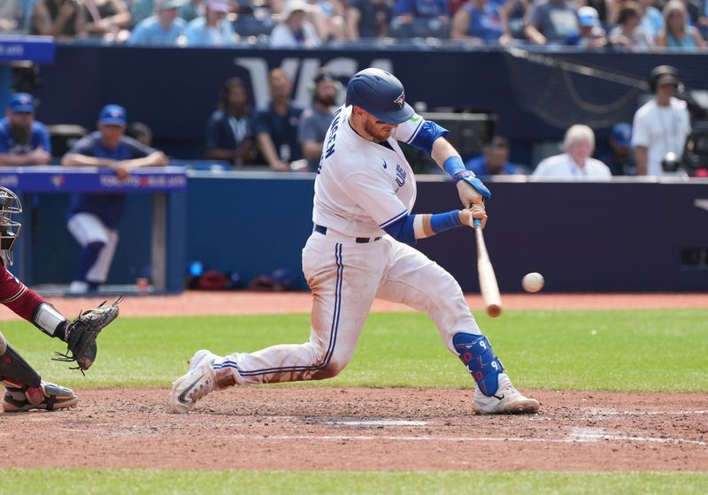 Jul 16, 2023; Toronto, Ontario, CAN; Toronto Blue Jays catcher Danny Jansen (9) hits a three run double against the Arizona Diamondbacks during the eighth inning at Rogers Centre. Mandatory Credit: Nick Turchiaro-USA TODAY Sports