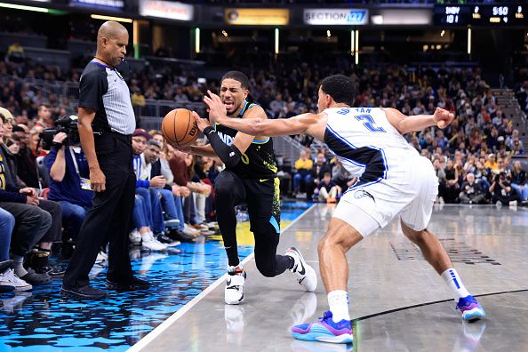 INDIANAPOLIS, INDIANA - DECEMBER 23: Tyrese Haliburton #0 of the Indiana Pacers is fouled by Caleb Houstan #2 of the Orlando Magic during the second half at Gainbridge Fieldhouse on December 23, 2023 in Indianapolis, Indiana. NOTE TO USER: User expressly acknowledges and agrees that, by downloading and or using this photograph, User is consenting to the terms and conditions of the Getty Images License Agreement. (Photo by Justin Casterline/Getty Images)