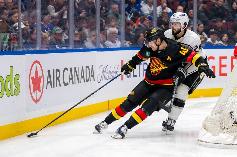 Mar 25, 2024; Vancouver, British Columbia, CAN; Los Angeles Kings forward Phillip Danault (24) cehcks Vancouver Canucks forward Elias Pettersson (40)  in the third period at Rogers Arena. Kings won 3 -2. Mandatory Credit: Bob Frid-USA TODAY Sports