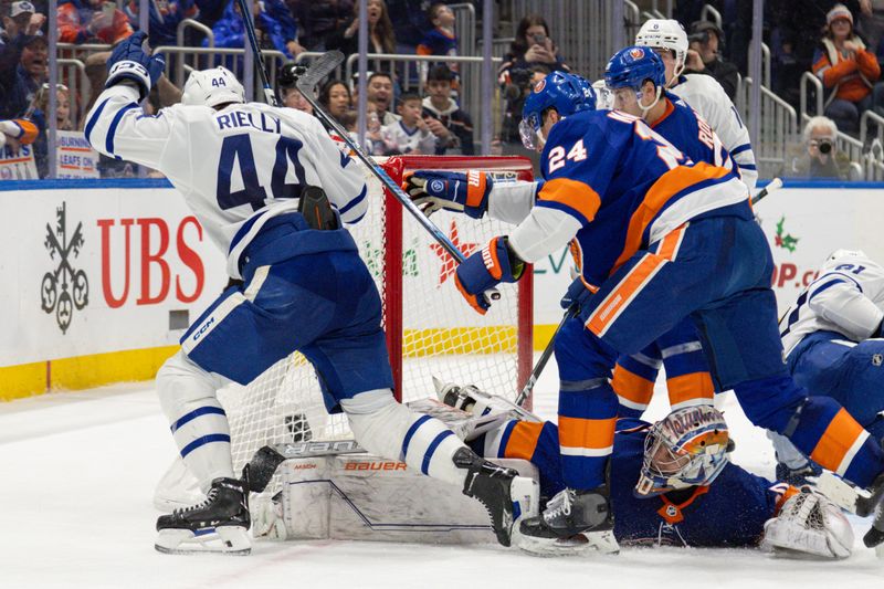 Dec 11, 2023; Elmont, New York, USA; Toronto Maple Leafs defenseman Morgan Rielly (44) celebrates his game tying goal against the New York Islanders during the third period at UBS Arena. Mandatory Credit: Thomas Salus-USA TODAY Sports