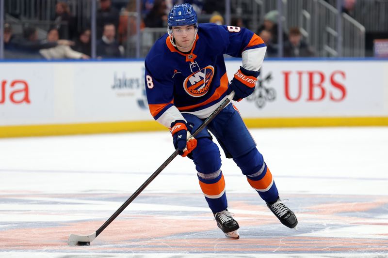 Dec 5, 2024; Elmont, New York, USA; New York Islanders defenseman Noah Dobson (8) skates with the puck against the Seattle Kraken during the second period at UBS Arena. Mandatory Credit: Brad Penner-Imagn Images