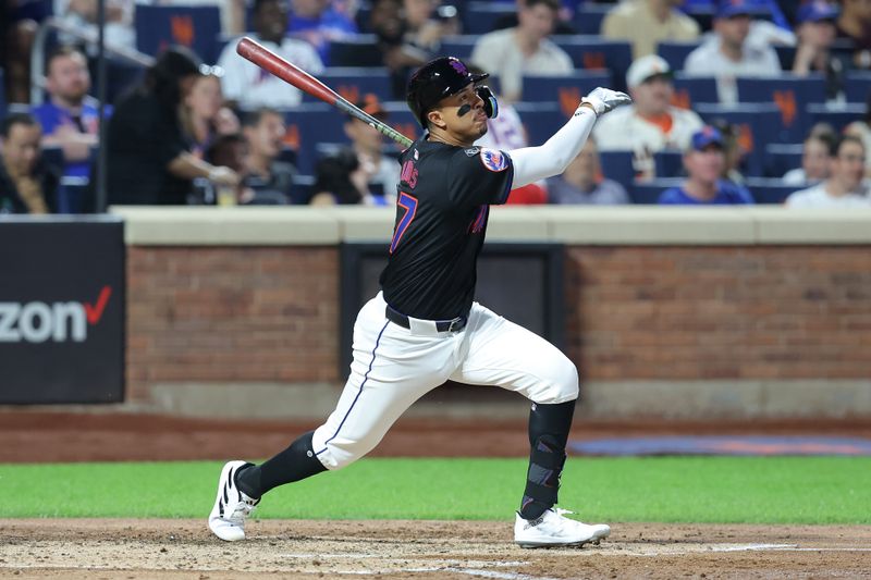 May 24, 2024; New York City, New York, USA; New York Mets third baseman Mark Vientos (27) follows through on a solo home run against the San Francisco Giants during the fifth inning at Citi Field. Mandatory Credit: Brad Penner-USA TODAY Sports