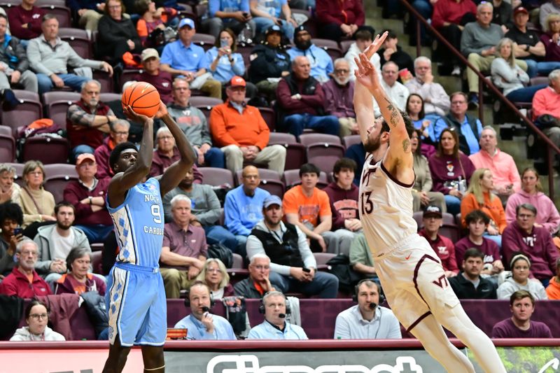 Mar 4, 2025; Blacksburg, Virginia, USA;  North Carolina Tar Heels guard Drake Powell (9) shoot a three point basket as Virginia Tech Hokies forward Ben Burnham (13) defends during the second half at Cassell Coliseum. Mandatory Credit: Brian Bishop-Imagn Images