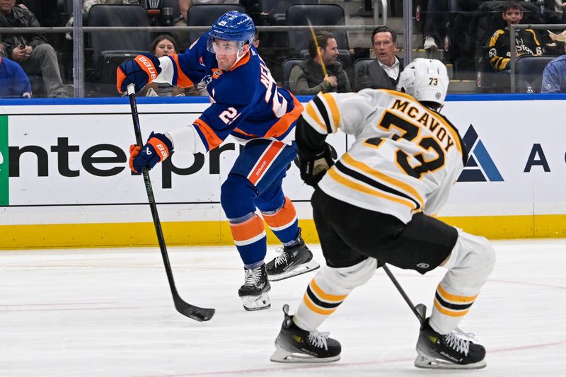 Nov 27, 2024; Elmont, New York, USA;  New York Islanders center Brock Nelson (29) attempts a shot defended by Boston Bruins defenseman Charlie McAvoy (73) during the second period at UBS Arena. Mandatory Credit: Dennis Schneidler-Imagn Images