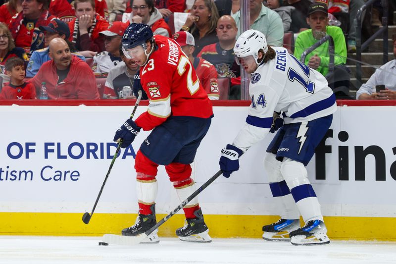 Apr 26, 2025; Sunrise, Florida, USA; Florida Panthers center Carter Verhaeghe (23) controls the puck from Tampa Bay Lightning center Conor Geekie (14) in the first period during game three of the first round of the 2025 Stanley Cup Playoffs at Amerant Bank Arena. Mandatory Credit: Nathan Ray Seebeck-Imagn Images