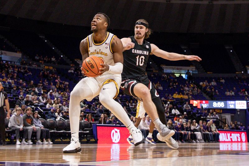 Feb 18, 2023; Baton Rouge, Louisiana, USA; LSU Tigers forward KJ Williams (12) drives to the basket against South Carolina Gamecocks forward Hayden Brown (10) at Pete Maravich Assembly Center. Mandatory Credit: Stephen Lew-USA TODAY Sports