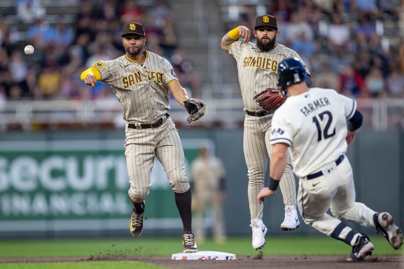 May 10, 2023; Minneapolis, Minnesota, USA; San Diego Padres shortstop Xander Bogaerts (2) forces out Minnesota Twins third baseman Kyle Farmer (12) at second base and throws the ball to first base for a double play in the seventh inning at Target Field. Mandatory Credit: Jesse Johnson-USA TODAY Sports