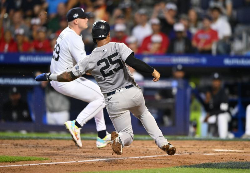 Aug 18, 2024; Williamsport, Pennsylvania, USA; New York Yankees infielder Gleyber Torres (25) slides home to score against the Detroit Tigers in the sixth inning at BB&T Ballpark at Historic Bowman Field. Mandatory Credit: Kyle Ross-USA TODAY Sports