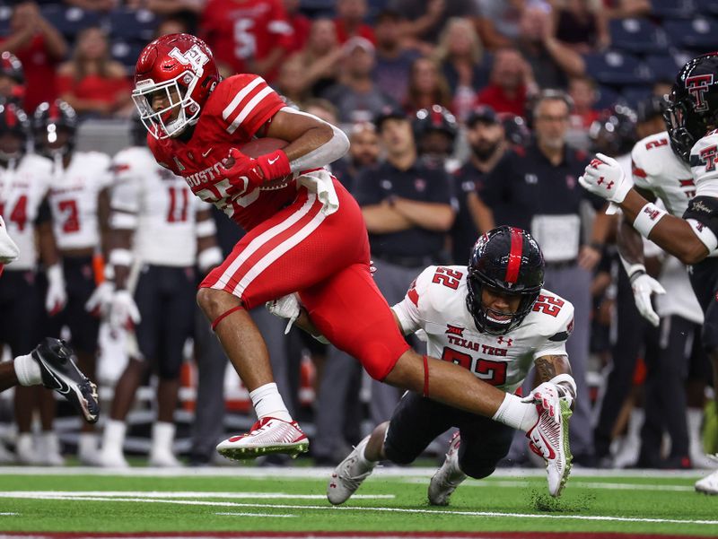 Sep 4, 2021; Houston, Texas, USA; Houston Cougars tight end Christian Trahan (85) makes a reception as Texas Tech Red Raiders defensive back Reggie Pearson Jr. (22) defends during the first quarter at NRG Stadium. Mandatory Credit: Troy Taormina-USA TODAY Sports