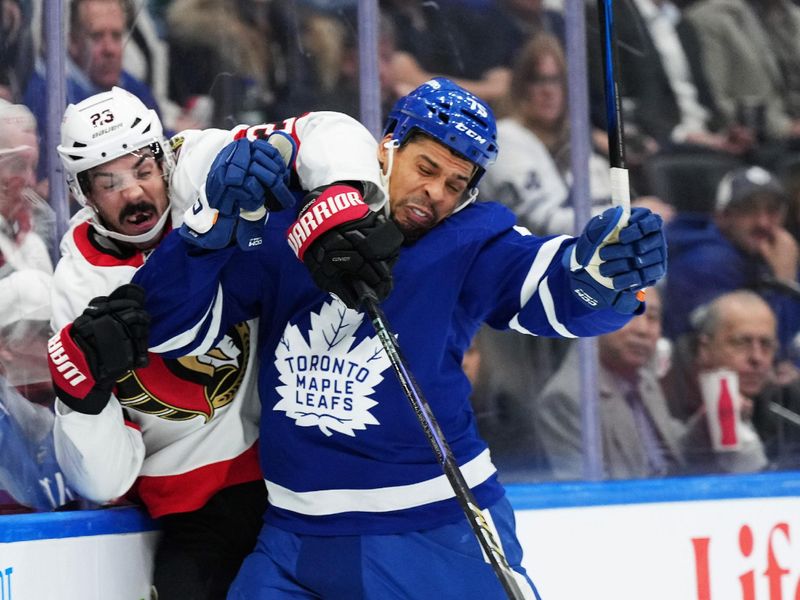 Nov 12, 2024; Toronto, Ontario, CAN; Toronto Maple Leafs right wing Ryan Reaves (75) battles along the boards with Ottawa Senators defenseman Travis Hamonic (23) during the first period at Scotiabank Arena. Mandatory Credit: Nick Turchiaro-Imagn Images