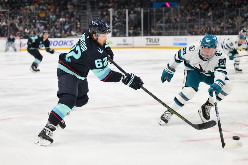 Nov 30, 2024; Seattle, Washington, USA; Seattle Kraken defenseman Brandon Montour (62) shoots the puck past San Jose Sharks left wing Fabian Zetterlund (20) during the second period at Climate Pledge Arena. Mandatory Credit: Steven Bisig-Imagn Images