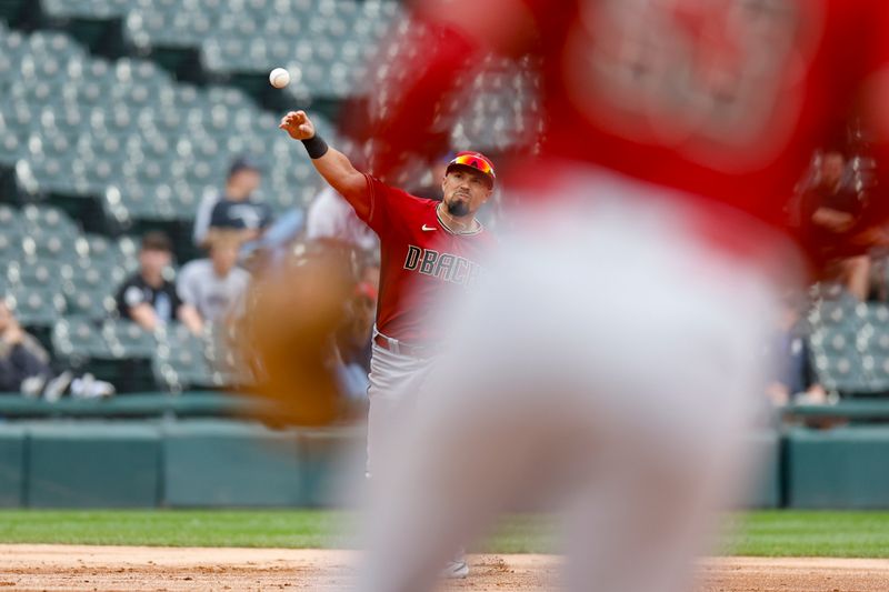 Sep 27, 2023; Chicago, Illinois, USA; Arizona Diamondbacks third baseman Jace Peterson (6) throws to first baseman Christian Walker (53) for a Chicago White Sox out during the second inning at Guaranteed Rate Field. Mandatory Credit: Kamil Krzaczynski-USA TODAY Sports