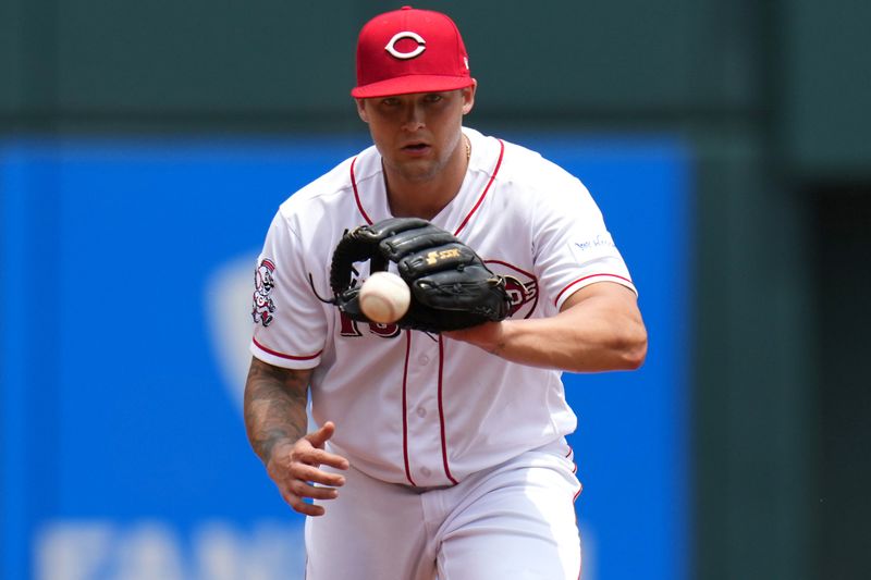 Jun 25, 2023; Cincinnati, Ohio, USA; Cincinnati Reds third baseman Nick Senzel (15) fields a ground ball in the second inning of a baseball game against the Atlanta Braves at Great American Ball Park. Mandatory Credit: Kareem Elgazzar-USA TODAY Sports