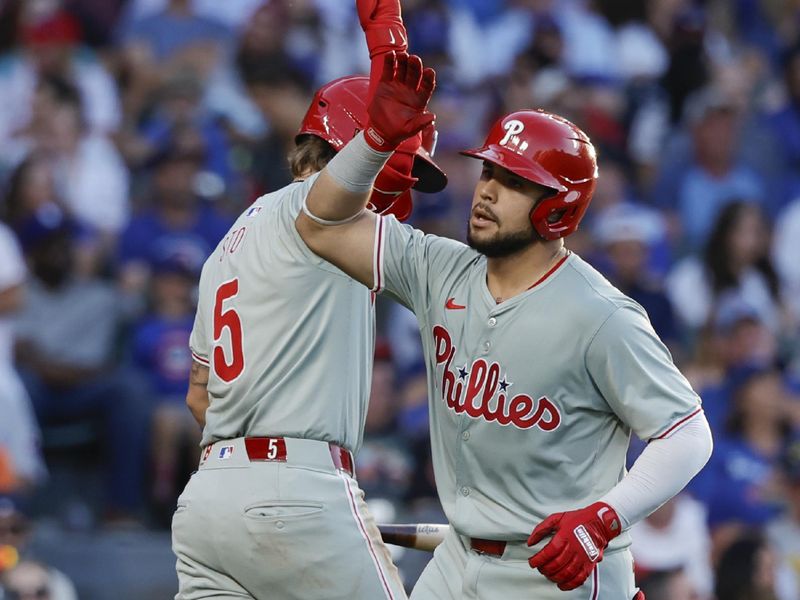 Jul 3, 2024; Chicago, Illinois, USA; Philadelphia Phillies catcher Rafael Marchan (13) celebrates with second baseman Bryson Stott (5) after hitting a solo home run against the Chicago Cubs during the third inning at Wrigley Field. Mandatory Credit: Kamil Krzaczynski-USA TODAY Sports