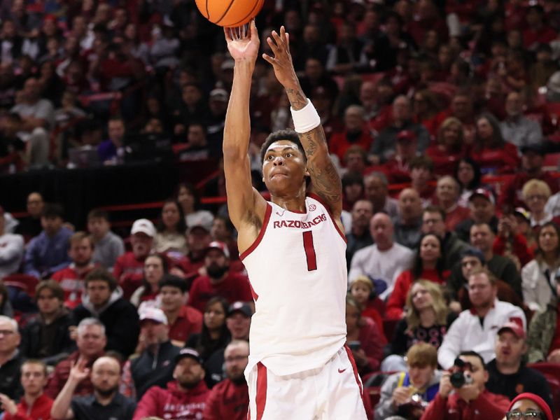 Dec 29, 2025; Fayetteville, Arkansas, USA; Arkansas Razorbacks guard Meleek Thomas (1) shoots a three point shot in the first half against the James Madison Dukes at Bud Walton Arena. Mandatory Credit: Nelson Chenault-Imagn Images