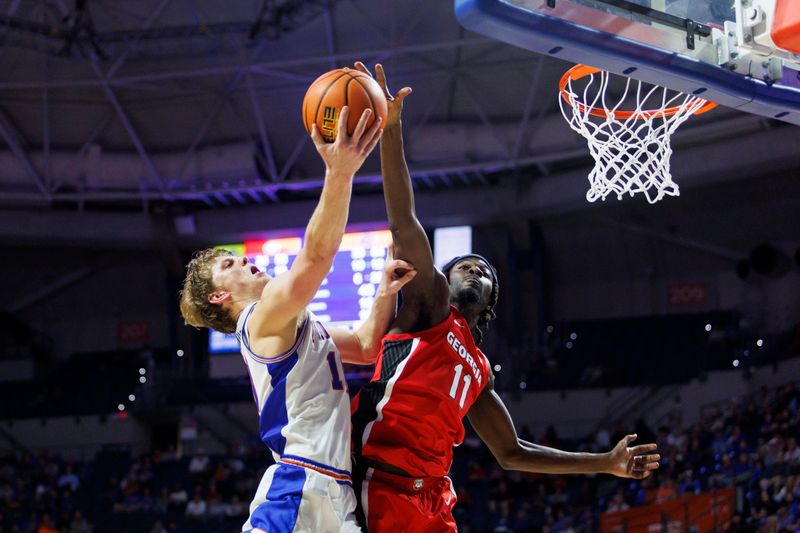 Jan 6, 2026; Gainesville, Florida, USA; Georgia Bulldogs forward Dylan James (11) blocks a layup from Florida Gators forward Thomas Haugh (10) during the second half at Exactech Arena at the Stephen C. O'Connell Center. Mandatory Credit: Morgan Tencza-Imagn Images