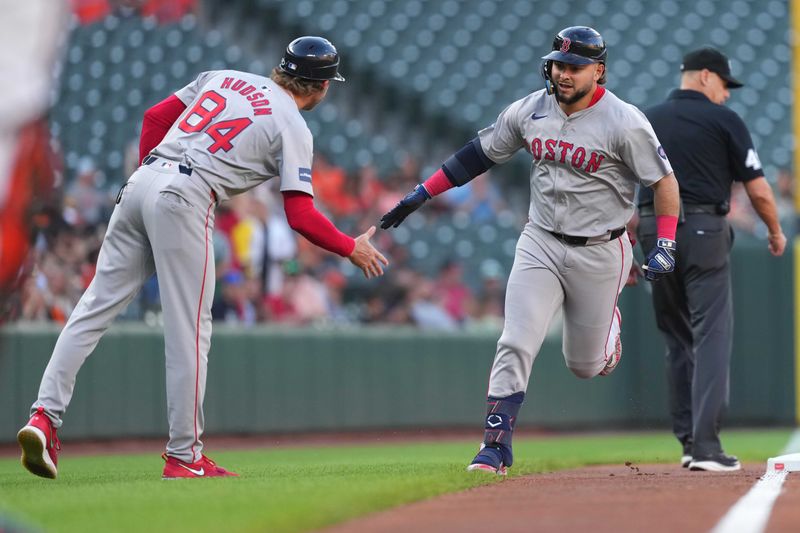 May 28, 2024; Baltimore, Maryland, USA; Boston Red Sox outfielder Wilyer Abreu (52) greeted by coach  Kyle Hudson (84) as he rounds the bases on a solo home run in the first inning against the Baltimore Orioles at Oriole Park at Camden Yards. Mandatory Credit: Mitch Stringer-USA TODAY Sports