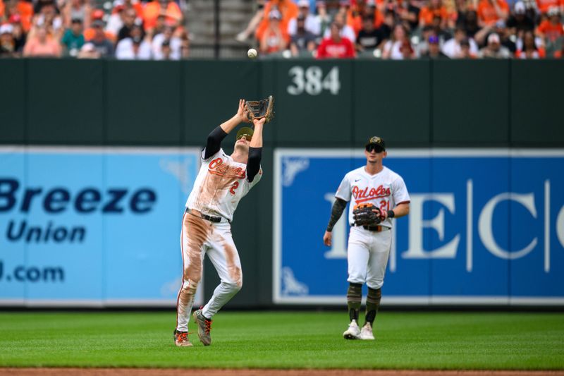 May 19, 2024; Baltimore, Maryland, USA; Baltimore Orioles shortstop Gunnar Henderson (2) makes a catch during the seventh inning against the Seattle Mariners at Oriole Park at Camden Yards. Mandatory Credit: Reggie Hildred-USA TODAY Sports