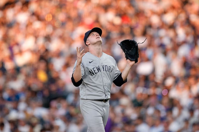 Jul 15, 2023; Denver, Colorado, USA; New York Yankees starting pitcher Clarke Schmidt (36) gestures as he walks to the dugout after being pulled in the seventh inning against the Colorado Rockies at Coors Field. Mandatory Credit: Isaiah J. Downing-USA TODAY Sports