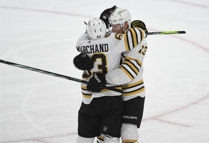 Apr 13, 2024; Pittsburgh, Pennsylvania, USA; Boston Bruins left wing Brad Marchand (63) celebrates a goal with center Charlie Coyne (13)against the Pittsburgh Penguins during the second period at PPG Paints Arena. Mandatory Credit: Philip G. Pavely-USA TODAY Sports