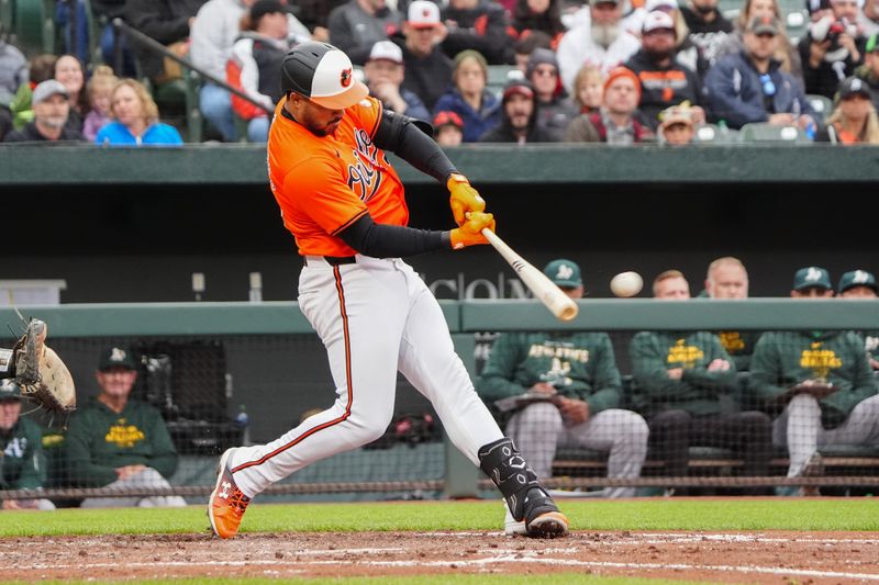 Apr 27, 2024; Baltimore, Maryland, USA; Baltimore Orioles right fielder Anthony Santander (25) hits a RBI double against the Oakland Athletics during the fourth inning at Oriole Park at Camden Yards. Mandatory Credit: Gregory Fisher-USA TODAY Sports