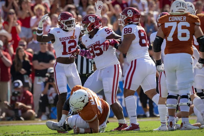 Oct 7, 2023; Dallas, Texas, USA; Oklahoma Sooners defensive back Key Lawrence (12) and defensive lineman Da'Jon Terry (95) and defensive lineman Jordan Kelley (88) celebrates a defensive stop against the Texas Longhorns during the first half at the Cotton Bowl. Mandatory Credit: Jerome Miron-USA TODAY Sports