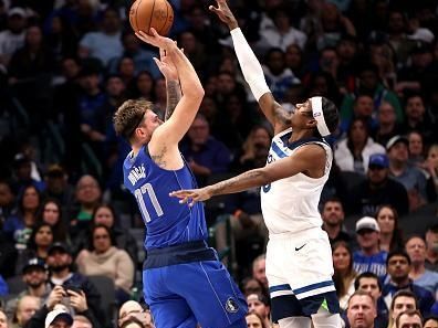 DALLAS, TEXAS - DECEMBER 14: Luka Doncic #77 of the Dallas Mavericks shoots the ball against Jaden McDaniels #3 of the Minnesota Timberwolves in the first half at American Airlines Center on December 14, 2023 in Dallas, Texas. NOTE TO USER: User expressly acknowledges and agrees that, by downloading and or using this photograph, User is consenting to the terms and conditions of the Getty Images License Agreement. (Photo by Tim Heitman/Getty Images)