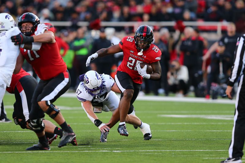 Nov 2, 2023; Lubbock, Texas, USA; Texas Tech Red Raiders running back Tahj Brooks (28) rushes against Texas Christian Horned Frogs defensive linebacker Johnny Hodges (57) in the first half at Jones AT&T Stadium and Cody Campbell Field. Mandatory Credit: Michael C. Johnson-USA TODAY Sports